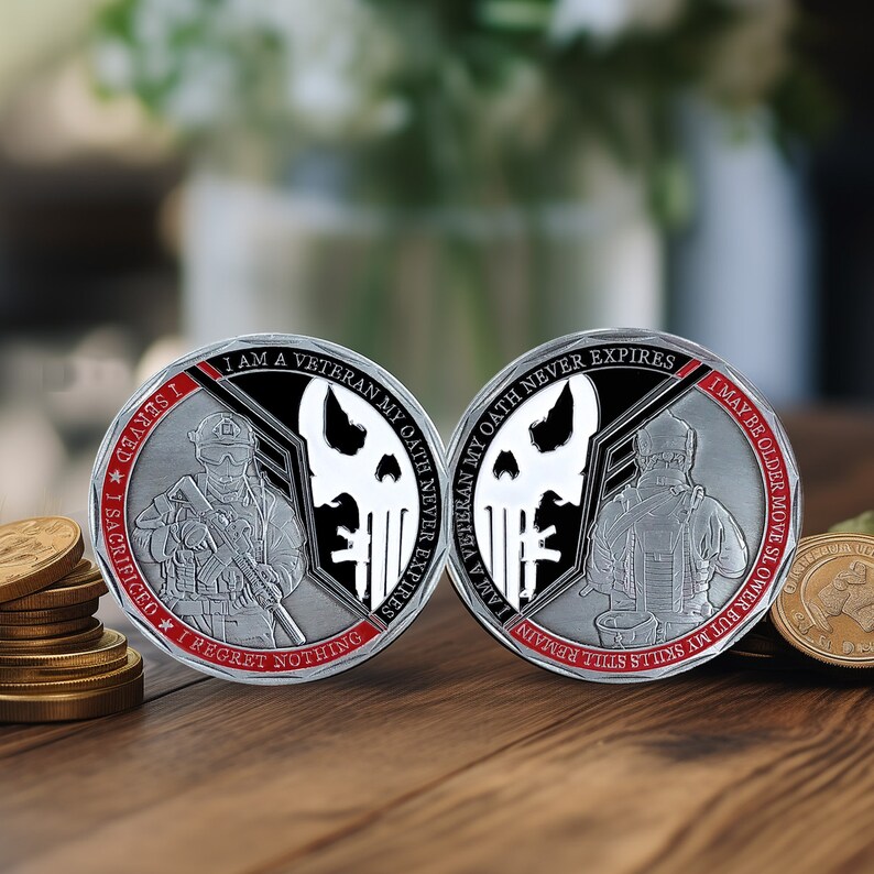 May include: Two silver challenge coins with black and white skull designs. The coins feature the text "I am a Veteran My Oath Never Expires" and "I served I sacrificed I regret nothing I may be older move slower but my skill remains still this ain't no human I am a Veteran My Oath Never Expires".