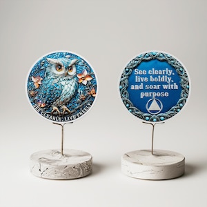 May include: Two decorative round plaques on stands. One features a detailed blue owl with the text "SEE CLEARLY, LIVE FREELY". The other has the text "See clearly, live boldly, and soar with purpose" on a blue background.