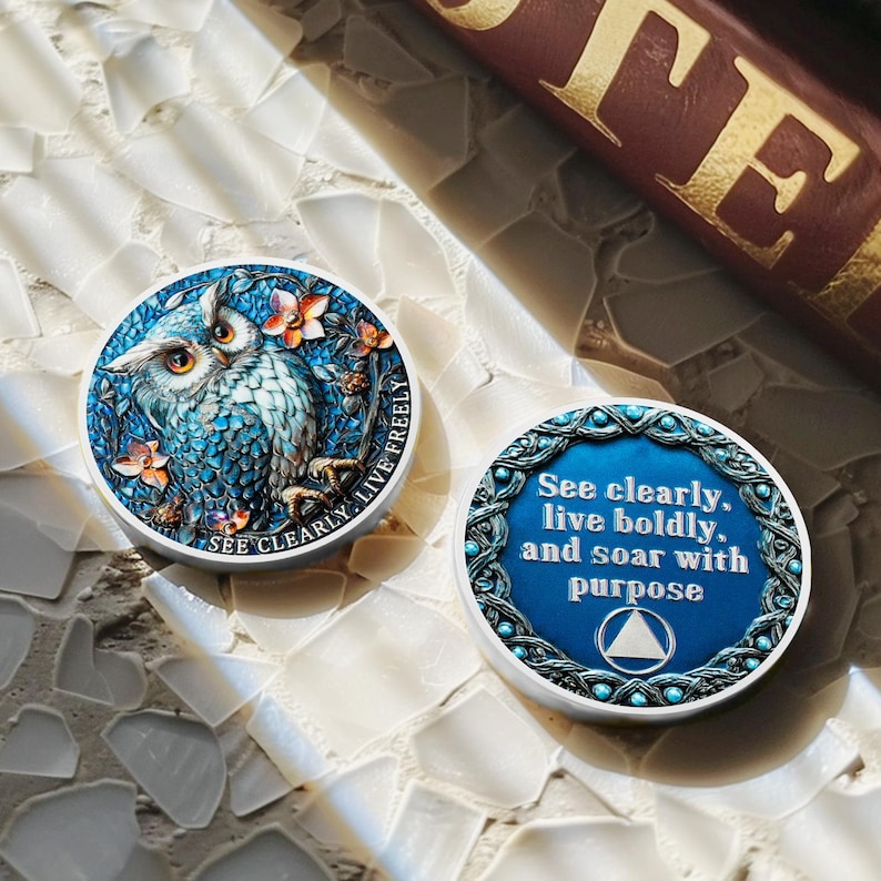 May include: Two round, decorative owl-themed objects. One features a blue owl with floral accents and the text "SEE CLEARLY. LIVE FREELY." The other has the text "See clearly, live boldly, and soar with purpose."