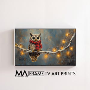 May include: A framed art print featuring a detailed painting of an owl perched on a snow-covered branch. The owl wears a red and black scarf and is surrounded by glowing string lights. The artwork is signed "Monterey Art" and the text "FRAME TV ART PRINTS" is displayed.