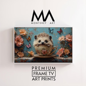 Puede incluir: Una impresión artística enmarcada con una ilustración caprichosa. Un erizo asoma de una taza de té floral, rodeado de mariposas y flores sobre un fondo azul. El texto "PREMIUM FRAME TV ART PRINTS" está en la parte inferior.