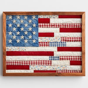 May include: A rectangular wall art piece featuring a patchwork American flag design enclosed in a medium-toned wooden frame. The flag is constructed from various fabric strips in red, white, and blue, incorporating floral, gingham, and polka dot patterns.
