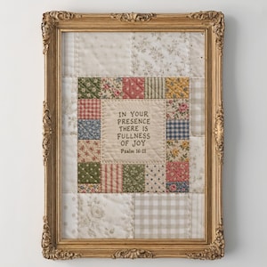 May include: A framed wall art piece featuring a central quilted panel with the embroidered text IN YOUR PRESENCE THERE IS FULLNESS OF JOY Psalm 16:11, surrounded by a border of small, multi-colored floral and checkered fabric squares.