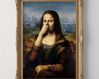 May include: A framed print of the Mona Lisa with a humorous twist. The subject is depicted with a finger touching her nose. The artwork is set against a landscape background and framed in a gold ornate frame.