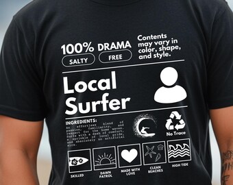 May include: Black t-shirt with a white graphic design that looks like a product label. The label says "100% Drama", "Salty", "Free", "Local Surfer", and "Contents may vary in color, shape, and style".