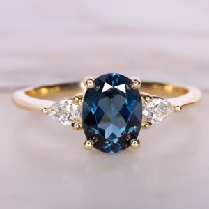 London Blue Topaz and Diamond Three Stone Ring in 14k Gold, Natural Stones, Oval Center With Pear Diamond Sides, Classic Basket Setting