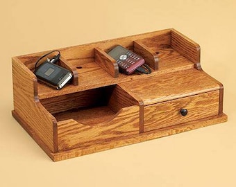 Power Up Your Space! Elevate Organization with Stylish Charging Station. Four device slots, drawer, and tray for ultimate functionality.