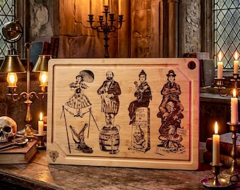 May include: A rectangular bamboo cutting board with a decorative engraving of vintage circus performers. The artwork includes a woman with an umbrella, a man on a barrel, and other figures. The board is set on a wooden table with candles and a skull.