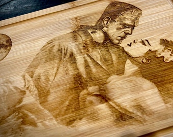 Cutting Board -  Frankenstein and Bride embraced engraved on heavy duty Bamboo wood.  Classic Monsters. Universal Monsters Charcuterie Board