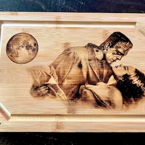 Cutting Board -  Frankenstein and Bride embraced engraved on heavy duty Bamboo wood.  Classic Monsters. Universal Monsters Charcuterie Board