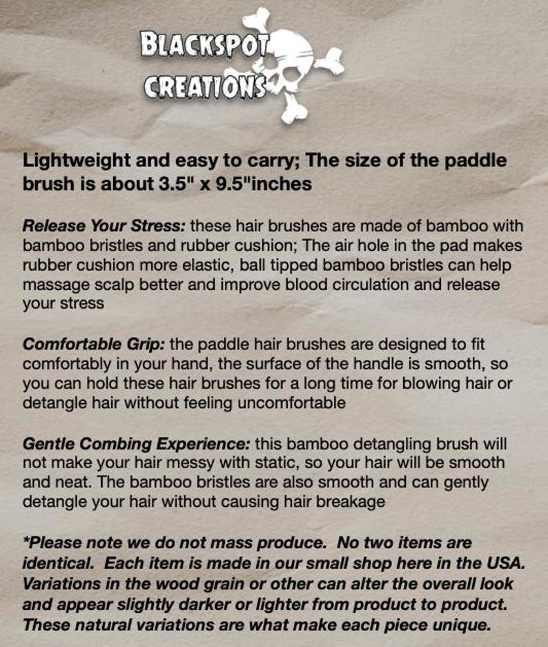 May include: A paddle hair brush made of bamboo with a rubber cushion. The brush is approximately 3.5 inches wide and 9.5 inches long. The text "BLACKSPOT CREATIONS" is at the top of the image.