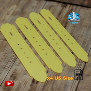 May include: Four yellow, elongated, 3D-printed objects with rounded ends and evenly spaced holes. The text "x4 US Size .stl" is visible. A 3D Print logo and a video icon are also present.