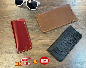 May include: Three different leather eyeglass cases. One is brown, one is red, and one is black with a crocodile pattern. The cases are all stitched with yellow thread. The image also includes a pair of white sunglasses and a download icon.