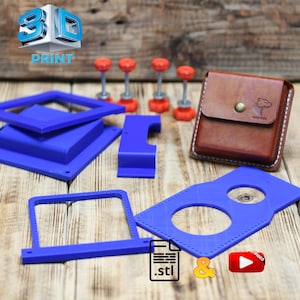 May include: An assortment of 3D printed blue plastic components, including frames and a plate with circular cutouts. Also, a brown leather wallet with a button closure and a logo, and several orange and silver fasteners.