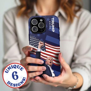 May include: A phone case with a blue, white, and red American flag design. The case features a photo of Donald Trump with the word "TRUMP" printed on the side.