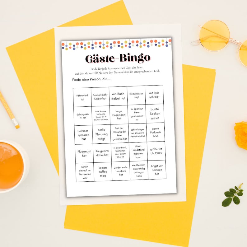 May include: A printable bingo card with the title "G&auml;ste-Bingo" in a colorful font. The card has a grid of 5x5 squares with various prompts in German, such as "10towiert ist" and "Kaugummi dabei hat".
