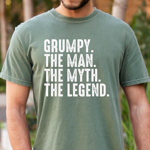May include: A green t-shirt with the text "GRUMPY. THE MAN. THE MYTH. THE LEGEND." printed in white.