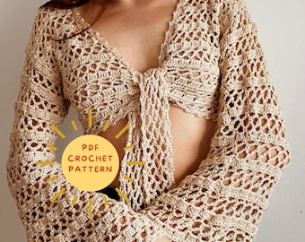 Könnte beinhalten: Ein Häkeltop mit Bindeband vorne und langen Ärmeln. Das Top ist in beige gehalten und hat ein zartes Lochmuster. Der Text "PDF CROCHET PATTERN" ist auf dem Bild zu sehen.