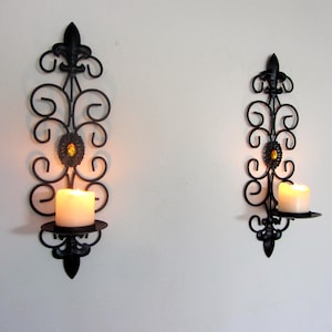 Pair of black metal scroll sconce&#39;s candle holders with acrylic amber jewel decoration Fleur de Lys 35cm