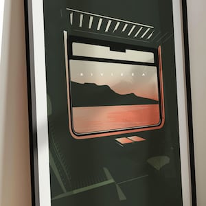May include: A framed print of a train window view with the word "RIVIERA" printed above a landscape scene of mountains and a body of water. The water is a light pink color and the mountains are a dark green color. The train window is framed in black and the interior of the train is a dark green color.