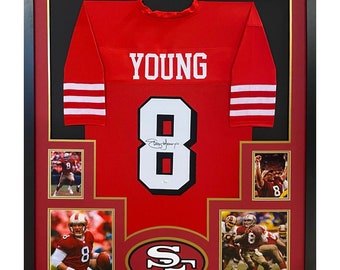 Könnte beinhalten: Gerahmtes rotes Trikot mit der weißen Nummer 8 und dem Namen "YOUNG" auf der Rückseite. Das Trikot ist von Steve Young signiert und trägt das Logo der San Francisco 49ers.