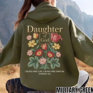 May include: A military green hooded sweatshirt featuring a back graphic with the text Daughter of God, surrounded by colorful illustrations of tulips and various flowers, with the text Created with love. Chosen with purpose. Ephesians 2:10.