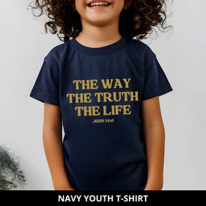 May include: Navy blue youth t-shirt with gold text: "THE WAY THE TRUTH THE LIFE" and "JOHN 14:6". The shirt is a classic crew neck style. The bottom of the image reads "NAVY YOUTH T-SHIRT".