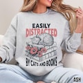 Easily Distracted By Cats And Books Shirt Cozy Bookish Sweatshirt Cat Lover Hoodie Reader Sweater Cute Literary Pullover Gift For Bookworms product logo