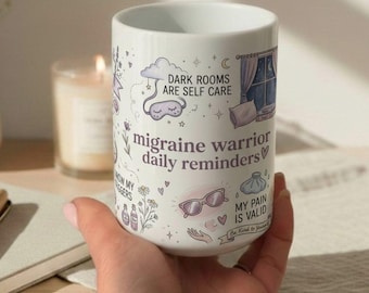 May include: White ceramic mug with the text "migraine warrior daily reminders" and other phrases and illustrations. The mug features a design with a sleep mask, sunglasses, and a window scene.