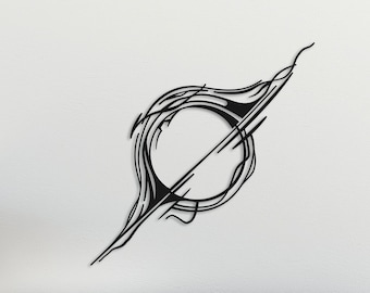 May include: A black metal wall art sculpture in the shape of a circle with a line through it. The sculpture is hanging on a white wall above a gray sofa with pillows and a throw blanket. There are two black coffee tables in front of the sofa.