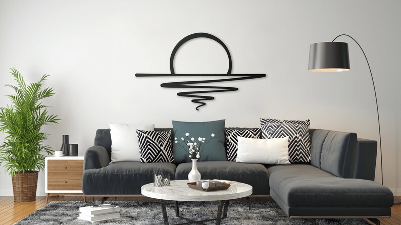 Metal wall art that features minimalist line art illustration of a sunset.