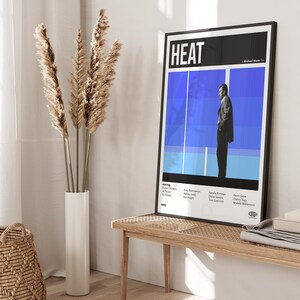 Pode incluir: Um cartaz de filme para o filme "HEAT" dirigido por Michael Mann. O cartaz apresenta uma imagem em preto e branco de Robert De Niro em um fundo azul e branco. O cartaz tamb&eacute;m inclui o t&iacute;tulo do filme, o diretor e o elenco.