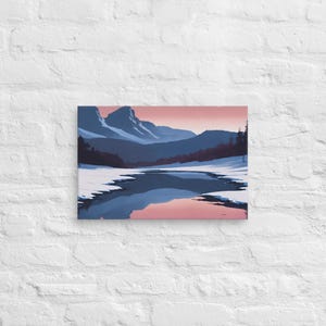 May include: A rectangular canvas print featuring a landscape illustration of snow-covered mountains and a dark blue river reflecting a soft pink sky. The scene includes dark silhouettes of trees along the horizon under a gradient sunset sky.