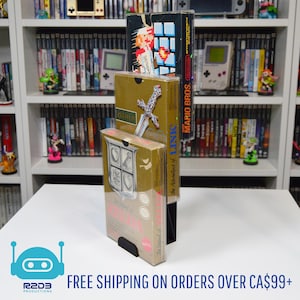 May include: Three retro video game boxes, including "The Legend of Zelda" and "Mario Bros.", are displayed on a white surface. The boxes are in a black stand, with a shelf of games in the background. The text "FREE SHIPPING ON ORDERS OVER CA$99+" is at the bottom.