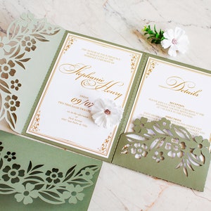 May include: A green and gold wedding invitation with a floral design. The invitation is for Stephanie and Henry, and the wedding is on Friday, September 7th, 2020. The invitation includes details about the reception and directions to the venue.