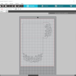 May include: A design for a card with a floral pattern cut out of the paper. The design is on a gridded surface.