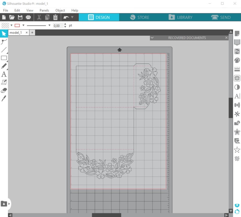 May include: A design for a card with a floral pattern cut out of the paper. The design is on a gridded surface.