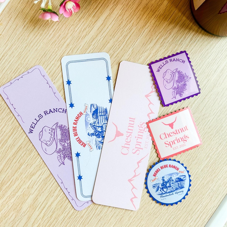 May include: A collection of Western-themed paper goods, including bookmarks and stickers. The bookmarks feature the text "Wells Ranch", "Rebel Blue Ranch", and "Chestnut Springs". The stickers display the text "Chestnut Springs EST. 2022" and "Rebel Blue Ranch".