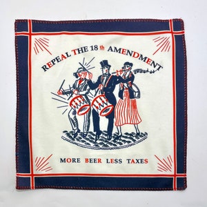 May include: Square white handkerchief with a navy blue border and red stitching. The center features a marching band illustration with the text "REPEAL THE 18TH AMENDMENT" and "MORE BEER LESS TAXES" in red and black.