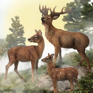May include: Three brown deer figurines in a natural setting. The largest deer has large antlers and is standing with its mouth open. The other two deer are smaller, one with white spots. The scene is set in a grassy area with trees in the background.