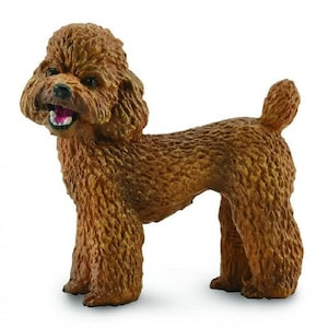 May include: A brown toy poodle figurine with a curly coat and a playful expression. The figurine is standing on a white background.