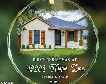 May include: A clear glass Christmas ornament with a photo of a house and the text "FIRST CHRISTMAS AT 43201 Maple Lane SOPHIA & DAVID 2023".