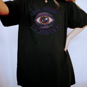 May include: Black oversized t-shirt with a graphic of an eye and the text "That wasn't a microdose".