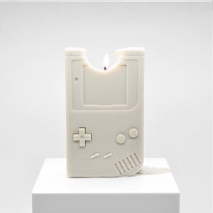 A partially melted candle that looks like the original Nintendo Gameboy.