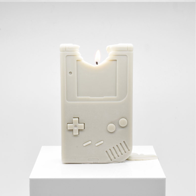 A partially melted candle that looks like the original Nintendo Gameboy.