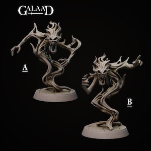 May include: Two gray fantasy figurines of a spectral creature with a skull-like face and flowing, flame-like hair. The figures are posed differently, one with arms outstretched and the other with a raised hand. The figures are on round bases.