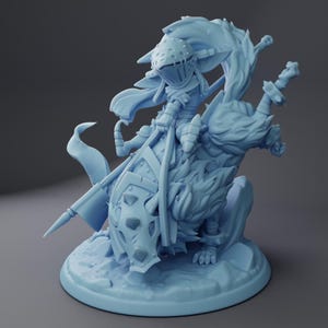 May include: A light blue figurine of a knight riding a wolf. The knight is wearing a helmet, armor, and carrying a shield and sword. The wolf has a furry mane and is posed on a rocky base.