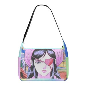 May include: A shoulder bag featuring a manga-style illustration of a woman with a pink heart-shaped eyepatch and a pink fluffy hat. The bag has a black strap and a colorful background with buildings.