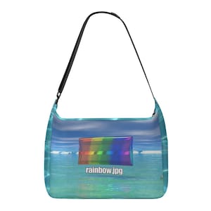 May include: A turquoise shoulder bag with a black strap. The bag features a rainbow graphic and the text "rainbow.jpg" against a backdrop of a seascape with blue sky and water.