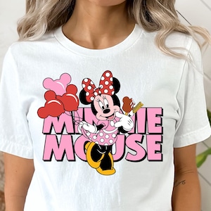May include: White t-shirt with a pink and red Minnie Mouse graphic and the text "Minnie Mouse".